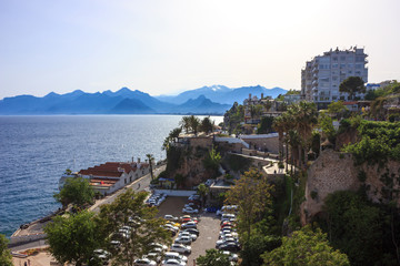 Fototapeta na wymiar Mediterranean landscape in Antalya. View of the mountains, sea, yachts and the city - Antalya, Turkey, 04.23.2019