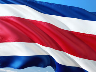 Flag of Costa Rica waving in the wind against deep blue sky. High quality fabric.