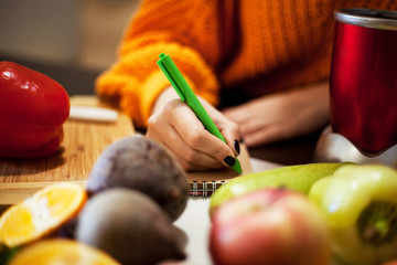 Housewife writing list to supermarket .