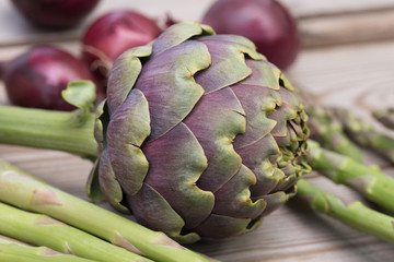 Obraz premium artichoke, asparagus, red onion healthy green and violet vegetables