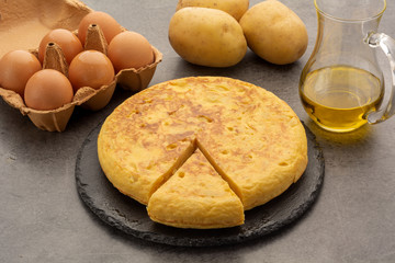 Spanish tortilla dish of potatoes with its ingredients: olive oil, potatoes and salt