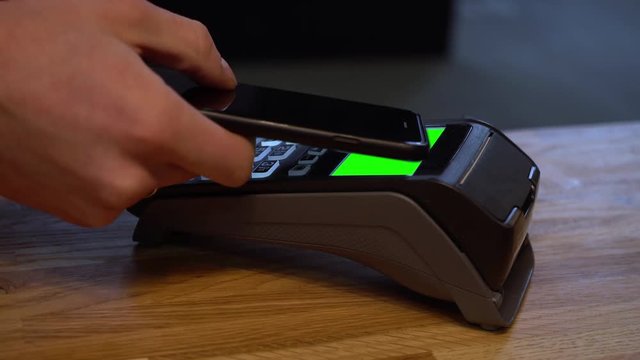 Mobile payments. Payment for purchases with a mobile phone with NFC technology. Payment accepted. POS terminal for electronic money. Virtual Wallet. Checkout store, cafe. Green screen