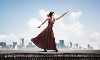 Obraz premium Blind woman in long red dress at top of building. Mixed media