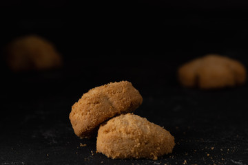 Close up view on cookies on a dark stone background. Sweet bakery coockie food. Dessert for coffee or tea. Homemade cuisine. Free copy paste space for text, logo