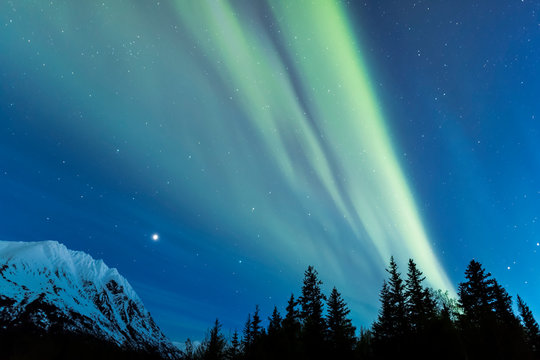 Faint Green Aurora Borealis Dances Over The  Kenai Mountains, Moose Pass, Kenai Peninsula, South-Central Alaska; Alaska, United States Of America