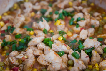 Chicken curry nuggets with vegetables on a frying pan