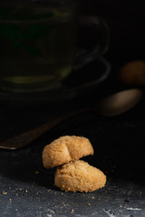Sweet cookies on stone table with cup of mint tea. Selective focus. Close up