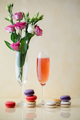 Glass of sparking wine or cocktail, flowers, macaroni