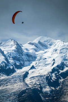A paraglider flying over Mont Blanc; Chamonix-Mont-Blanc, Haute-Savoie, France