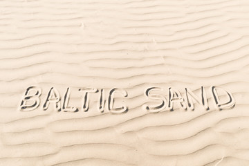 Fototapeta na wymiar word on sand. Baltic Sand.