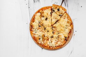 Sliced pizza with ingredients on white background. Top view, flat lay with copy space
