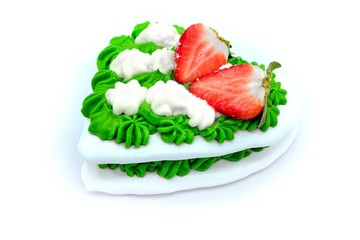Green meringue cake with strawberries. French dessert with whipped cream. Delicious cake covered with green cream. White background (Isolated)