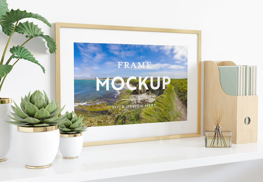 Horizontal Frame Leaning on Shelf with Plants and Books Mockup