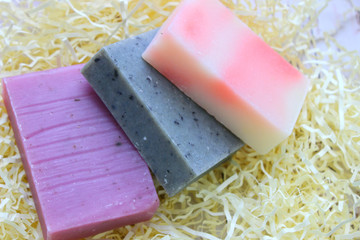 Several pieces of colorful handmade soap. Copy space. Natural soap with lavender, rose and coffee.
