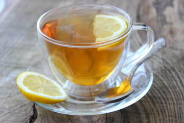 Cup of tea with lemon on wooden background. Copy space for your text.