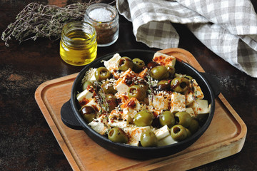 Feta pieces baked with olives and spices. Healthy lunch or snack. Keto diet Keto recipe.
