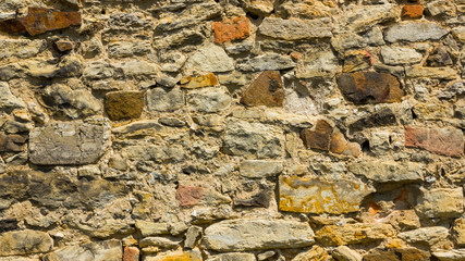 Background of old stone wall. The texture of the stone surface. Brickwork in the old European city. Pattern in retro style