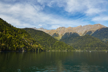Landscape with mountains, forest and a lake in front