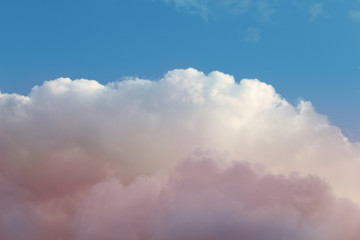 white, fluffy, cumulus clouds on a blue sky background below, copy space