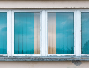 Windows with turquoise blue blinds