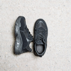 black sneakers on a thick sole on a concrete background