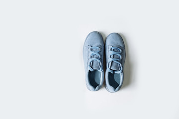 pair of blue suede shoes with thick laces on a white background