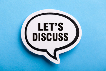Let Us Discuss Speech Bubble Isolated On Blue Background