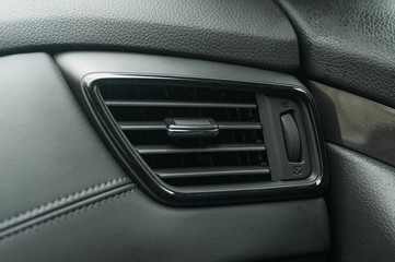 Obraz na płótnie Canvas Air conditioner system in modern car, closeup. air duct grille of modern car.