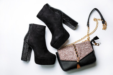 black suede ankle boots on a platform and thick heels with sparkles and a black bag with sparkles...