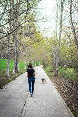 Woman with her cute female beagle dog in the park. Moscow.