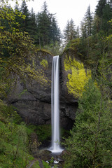 long exposure of Oregon waterfall in green forest
