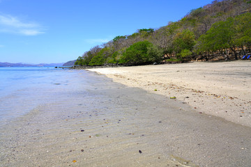 View of the black sand volcanic Playa Sombrero Obscuro beach in Peninsula Papagayo in Guanacaste, Costa Rica