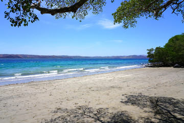 View of the black sand volcanic Playa Sombrero Obscuro beach in Peninsula Papagayo in Guanacaste, Costa Rica