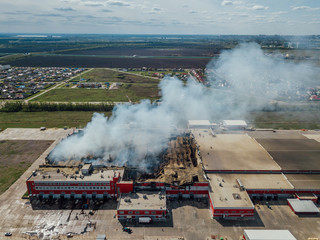 Aerial view of burning industrial distribution warehouse