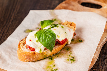 Traditional italian bruschetta with cherry tomatoes, cream cheese, basil leaves