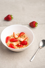 breakfast of oatmeal with strawberries, flat lay