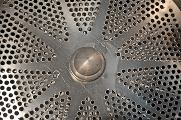 silver industrial metal separator closeup with many hole, industry diversity