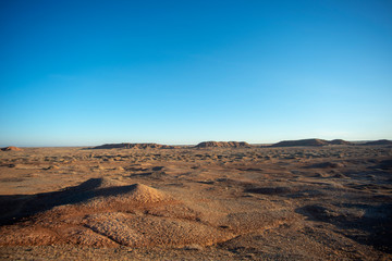 Golden deserts and hills at sunrise.