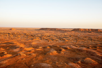 Golden deserts and hills at sunrise.