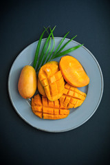 Exotic ripe mango half slice diced on plate