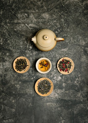 tea ceremony concept, Chinese or japanese traditions. teapot, cup of tea on dark background, several kinds of tea welding. variety of tea selection. Asia culture design concept. Top view, copy space