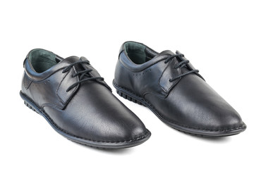 Black leather men's shoes standing side by side isolated on white background.