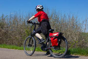 Fototapeta premium cyclists on an electric bike on a bikeway
