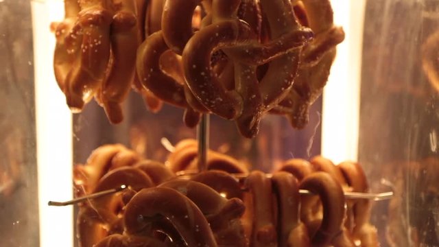 Pretzels hanging on a hook spinning slowly bright light