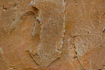 Background texture of orange stone with cracks and irregularities. Blur, close-up, top view, plenty of space for text, no one. Concept of design.