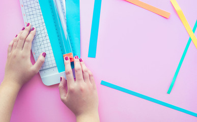 Young woman making paper art in colorful with pink space background