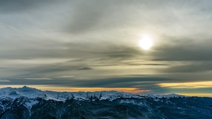 Sunset over the Caucasus mountains covered by snow in the ski resort of Krasnaya Polyana, Russia.