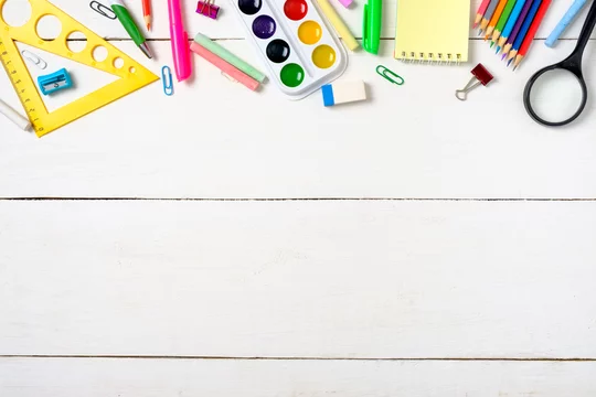 School supplies on wooden desk. Kid creativity flat lay Stock