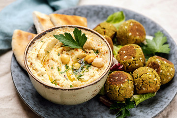 Chickpea Hummus and Falafel on a plate. Healthy arabic vegetarian appetizer food. Closeup view