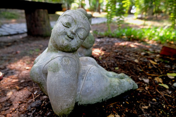 statue of woman play yoga in garden